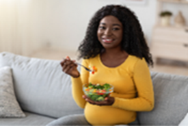 Pregnant person eating salad